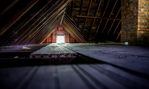 Old attic space with roof rafters and a window